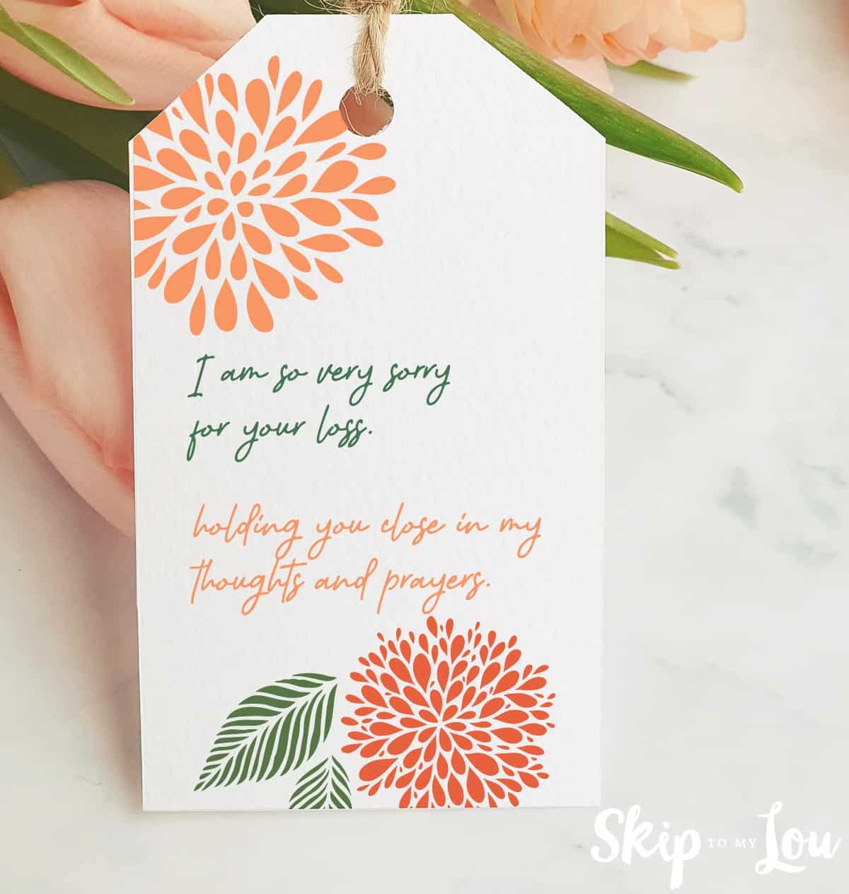 sympathy message tag tied to a bouquet of flowers.