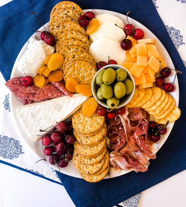 A summer charcuterie board from around my family table with cheese, crackers, and meat.