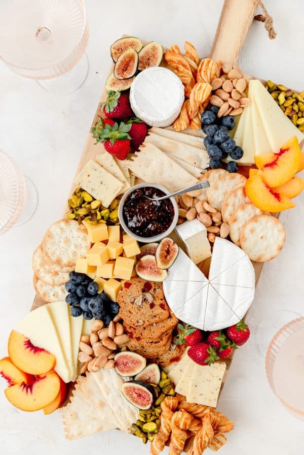 A board full of choices like peaches, cheese, breads, and more fruit from barley and sage