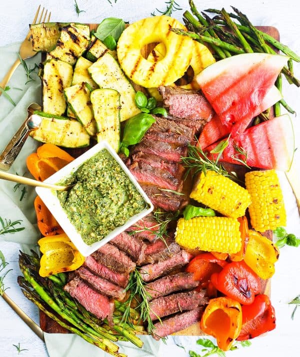 grilled steak, pineapple, corn, and watermelon on a bed of herbs from beautiful eats and things