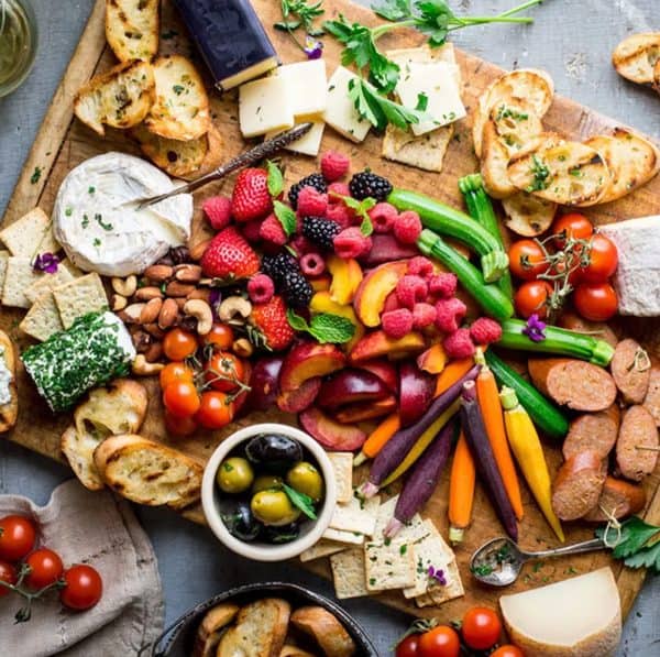 colorful carrots, cheese, olives, and fruit make up this charcuterie board from eating well.