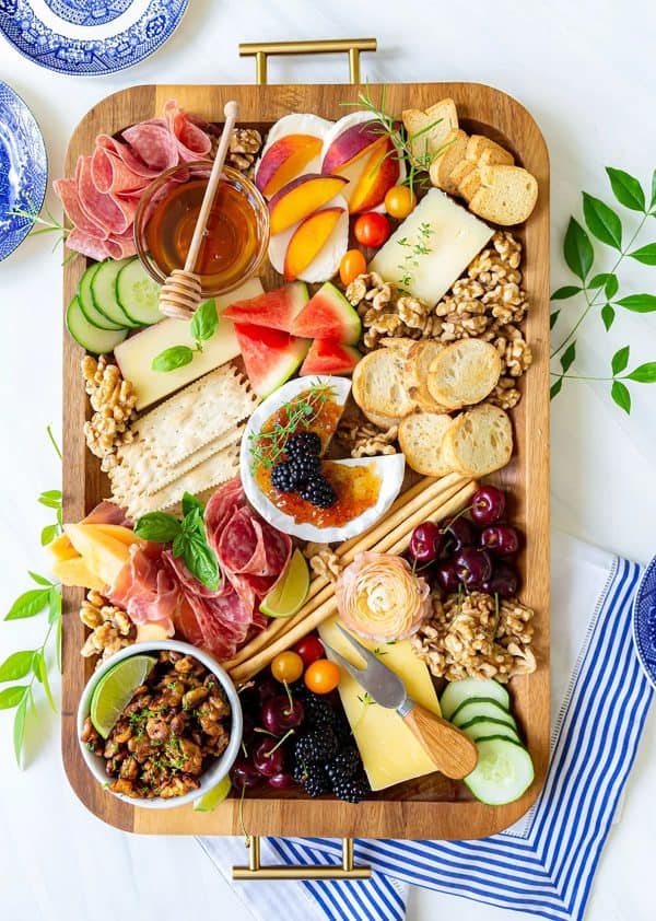 charcuterie tray from pizzazzerie with bread, dips, cheese, fruit, and more.