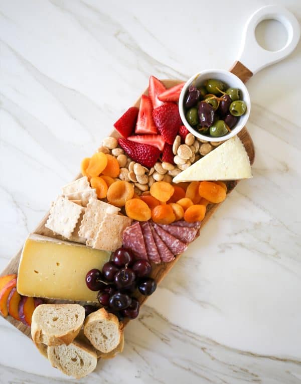 a simple and small board from sbkliving with cheese, dried fruit, and dips.