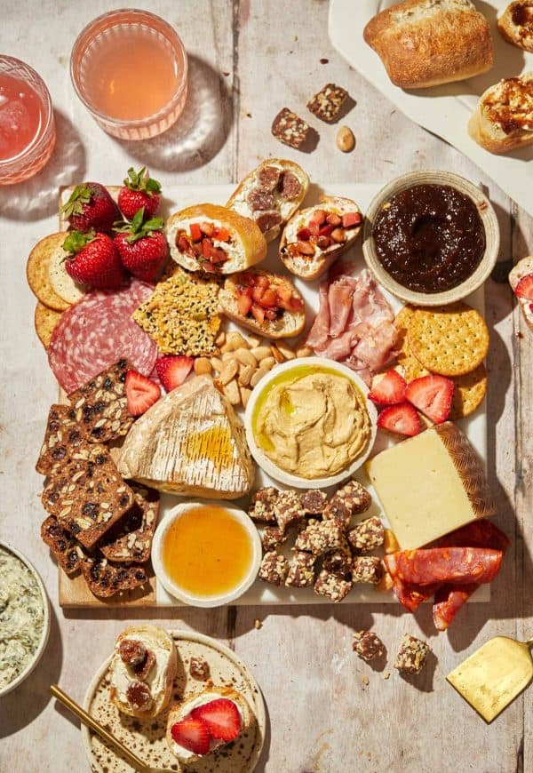A charcuterie board with hummus, fig jam, cheese, and more from the nutritious kitchen