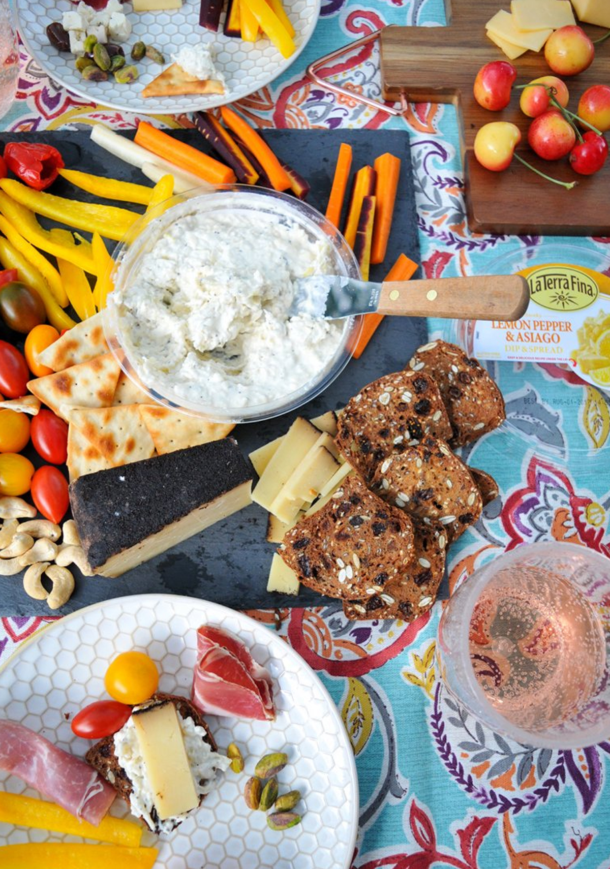 nosh and nourish's simple board with lemon pepper asiago spreadable cheese, veggies, crackers and more.