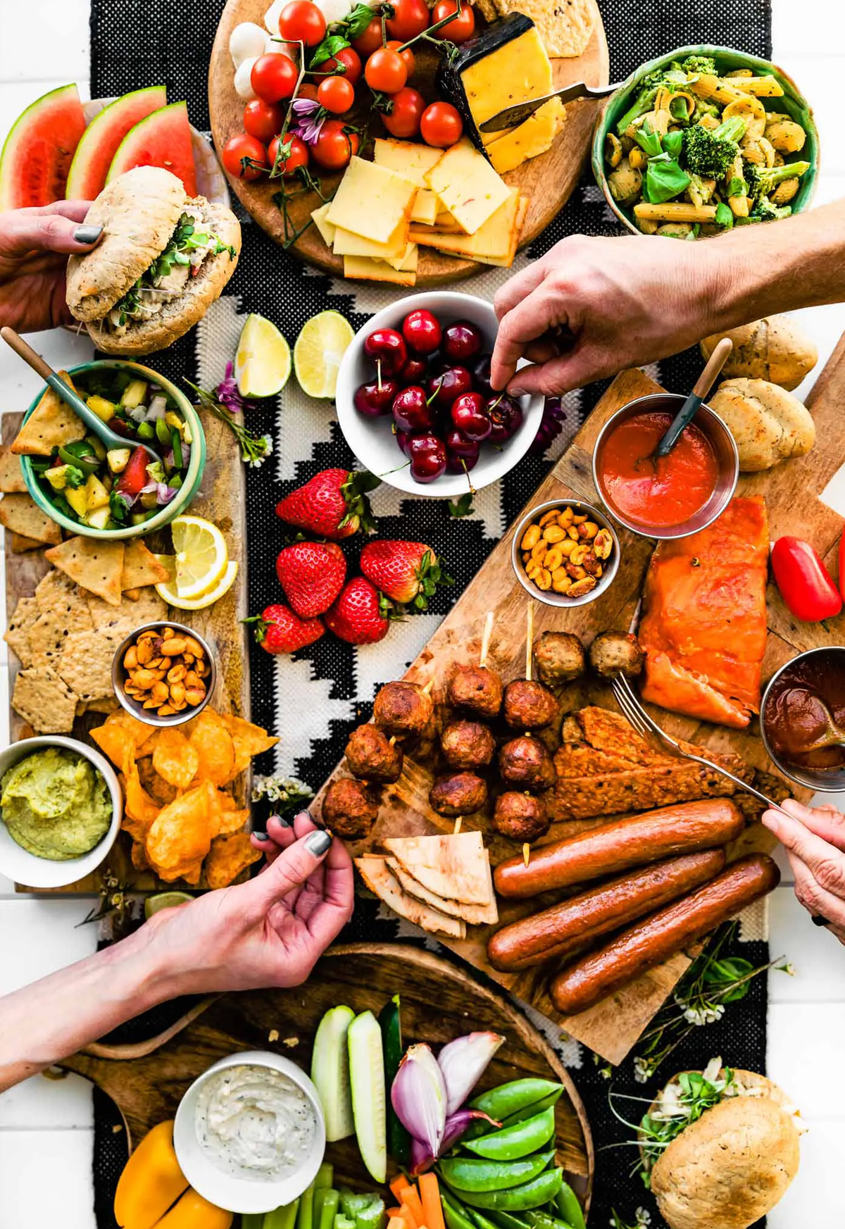 cotter crunch includes some healthy options on their bbq charcuterie board like veggies, fruits, and grilled salmon.