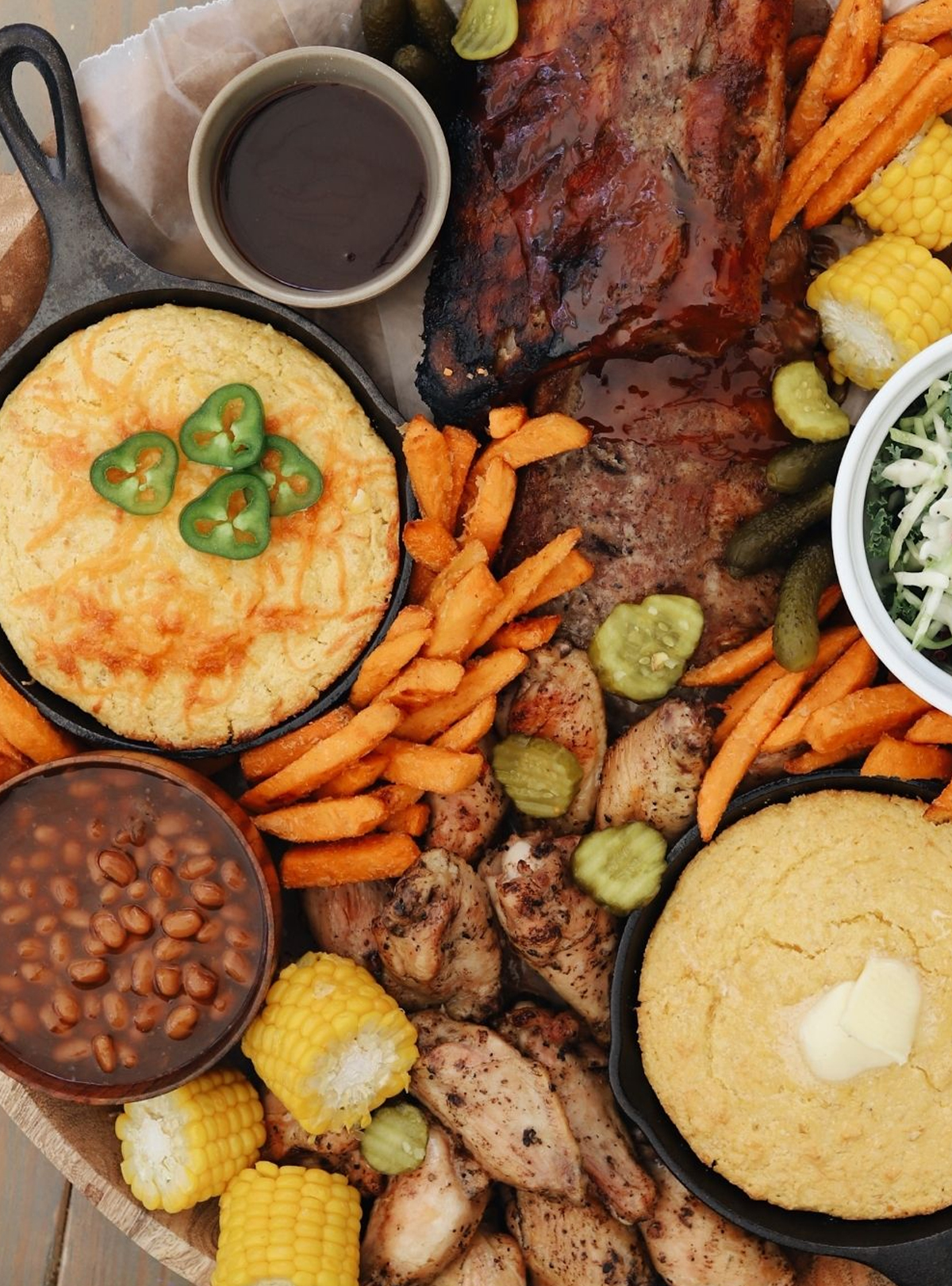 Fresh mommy blog has multiple types of cornbread, corn on the cob, grilled chicken wings, and even sweet potato fries.