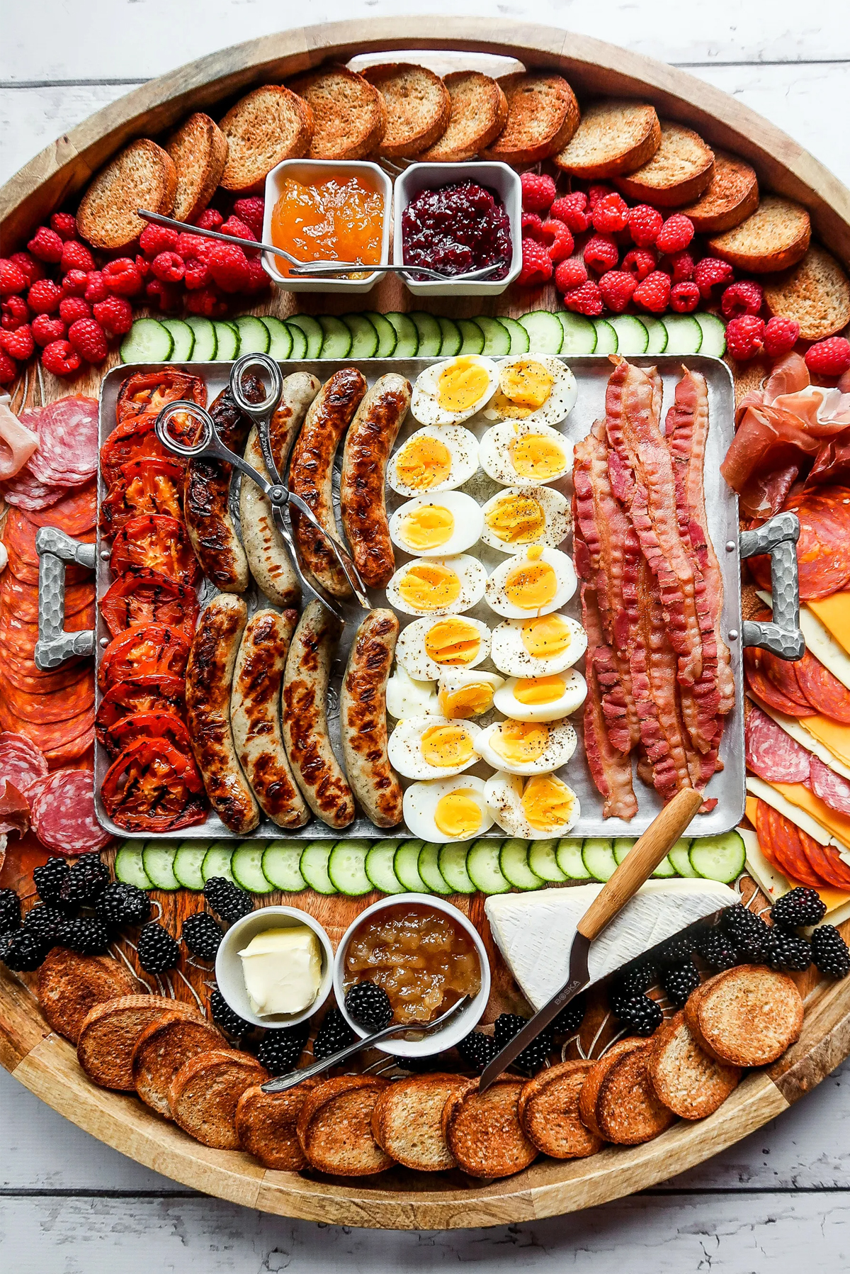 breakfast bbq board with charcuterie meats, bacon, grilled sausage links, and more from reluctant entertainer.