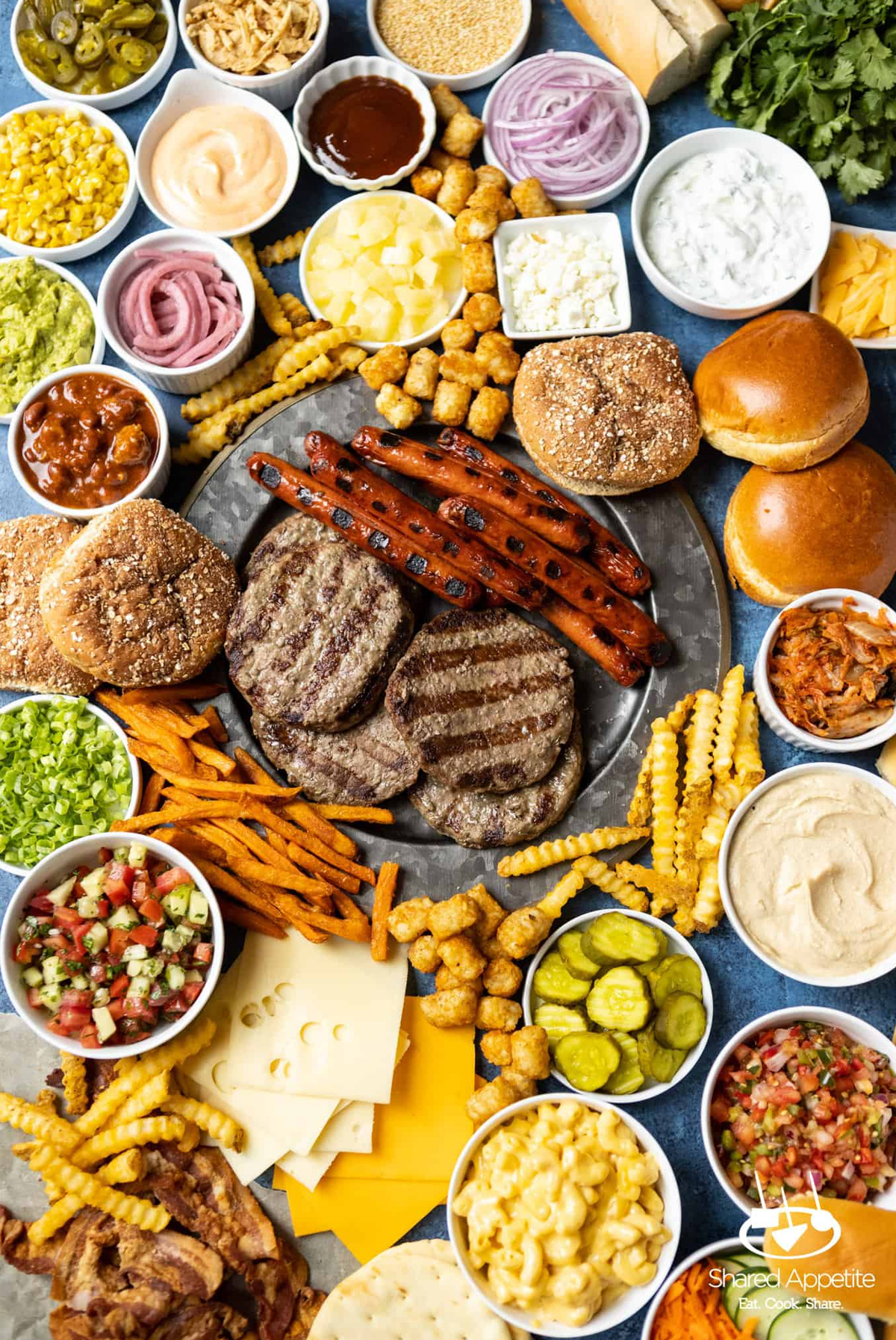 hamburgers and hot dogs is classic bbq food and these bbq charcuterie board idea from shared appetite includes everything.