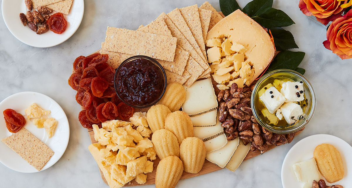 Murray's Cheese has created a simple board with cheese options, jam, and some delicious sweet cookies.