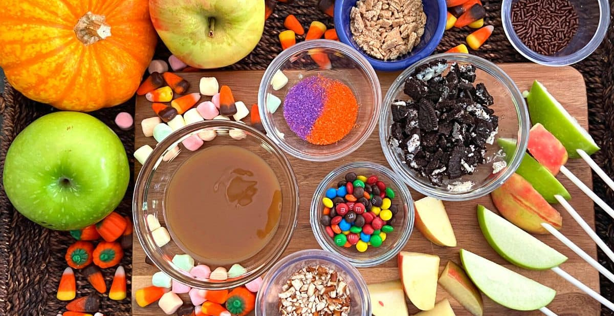 Apple slices, sprinkles, caramel sauce, Oreos, m&m's, and marshmallows, fill Little Cooks Reading Books Fall apple board.