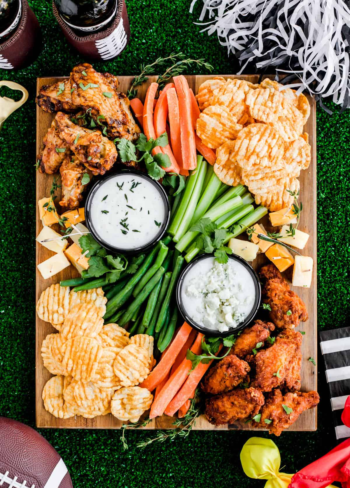 Celebrations at Home Blog's football board includes veggies, chicken wings, carrots, celery, and cheese.