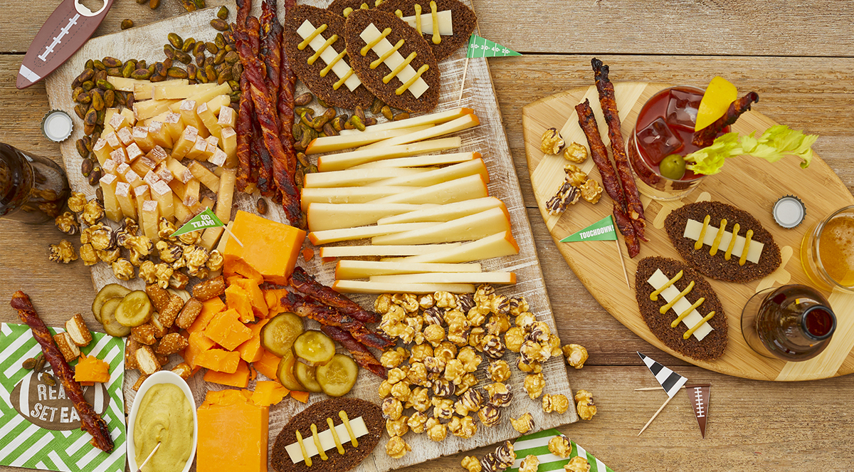 Wisconsin Cheese's football board includes a variety of cheese, meats, and popcorn.