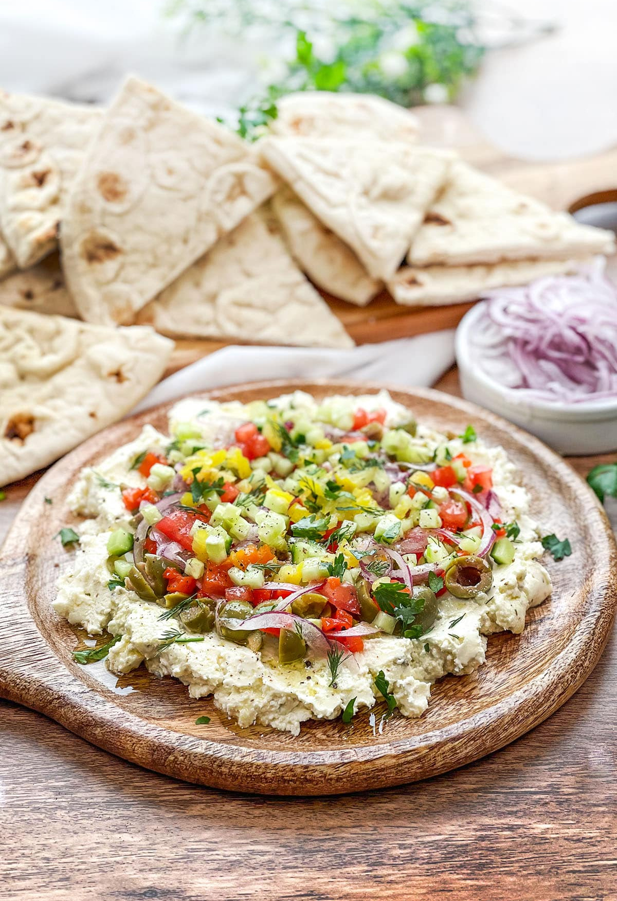 a whipped feta cheese dip from cook the story includes cucumbers, cherry tomatoes, peppers, and more.