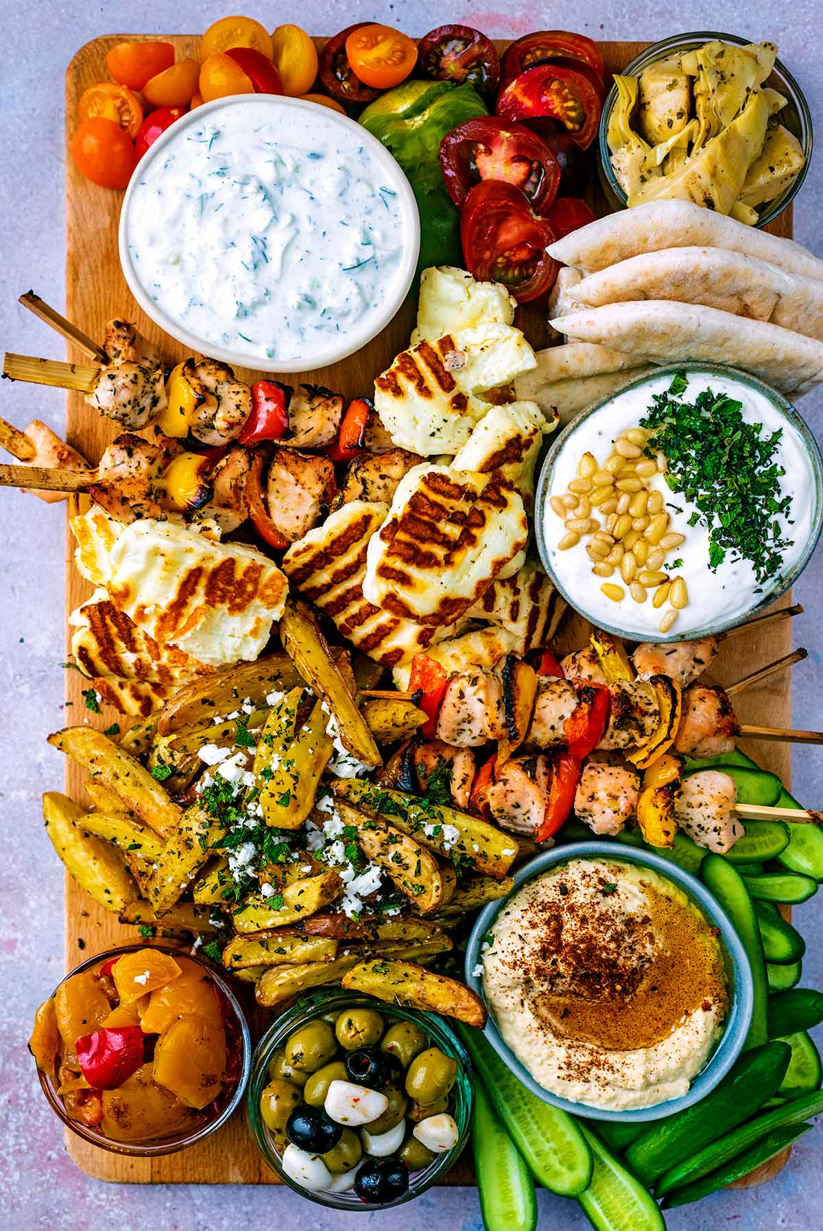 hungry healthy happy created a simple grilled skewer board with chicken skewers, dips, and veggies.