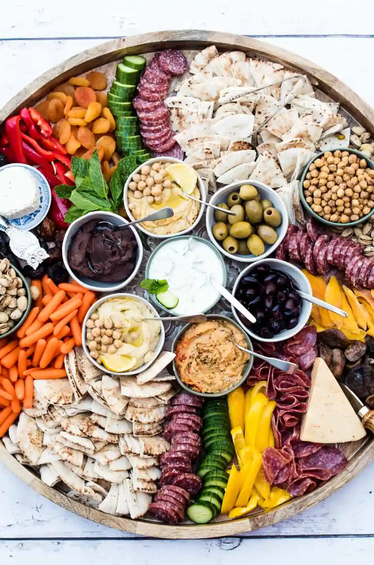 reluctant entertainer created a large board with over 4 different types of dips, meats, veggies, and more.