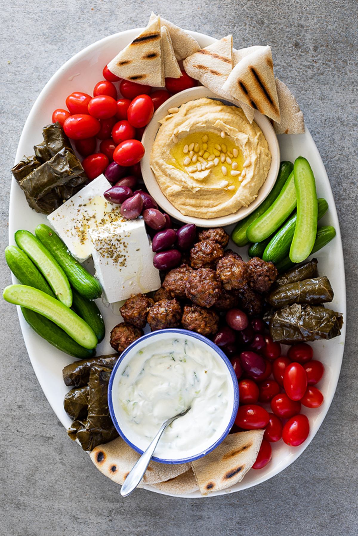 tzatziki dip, hummus, and veggies create this small plate from simply delicious food.