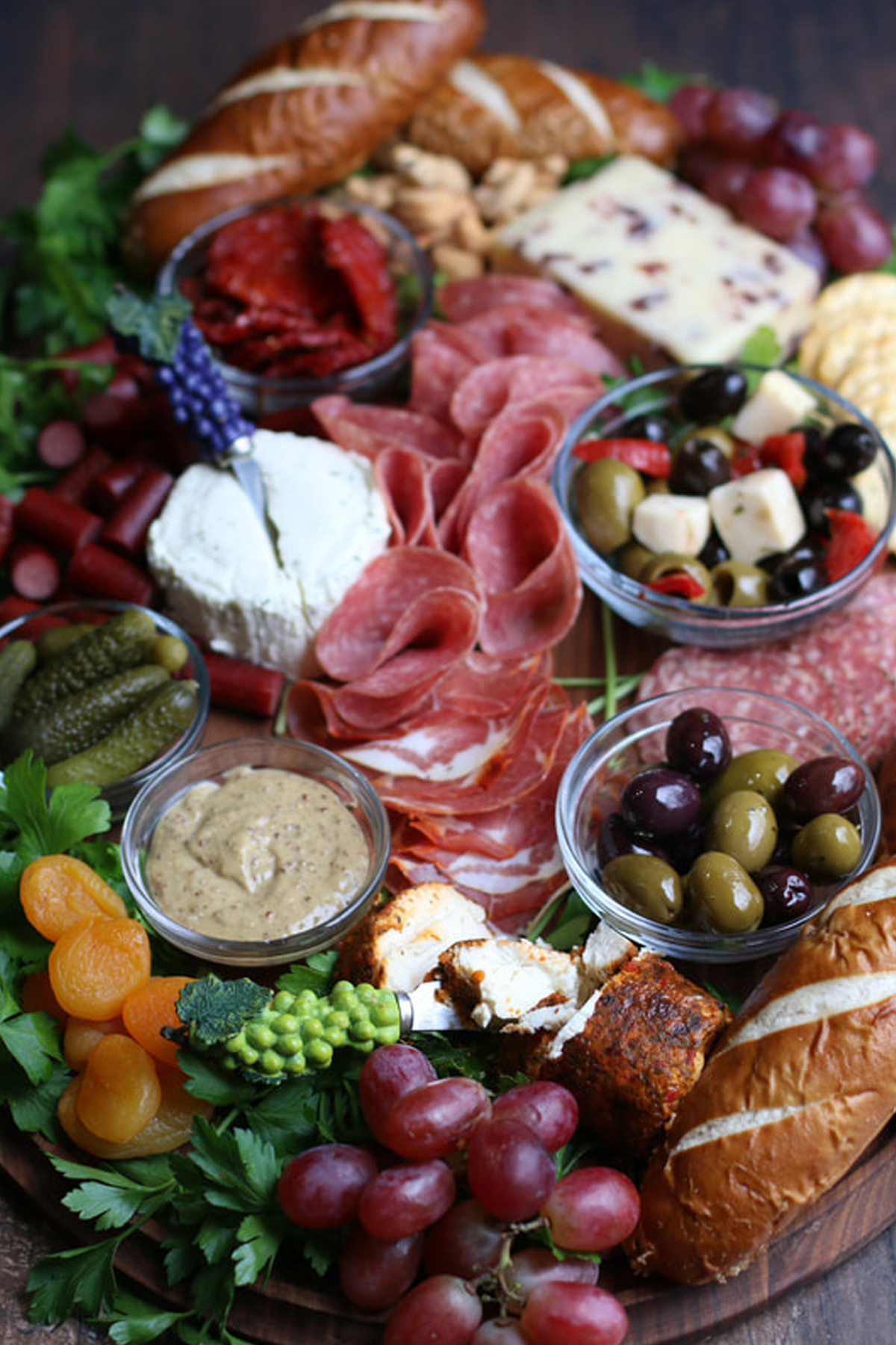 Snowflakes and coffeecakes has created a gourmet greek cheese board with a variety of cheese, marinated olives, and meat.