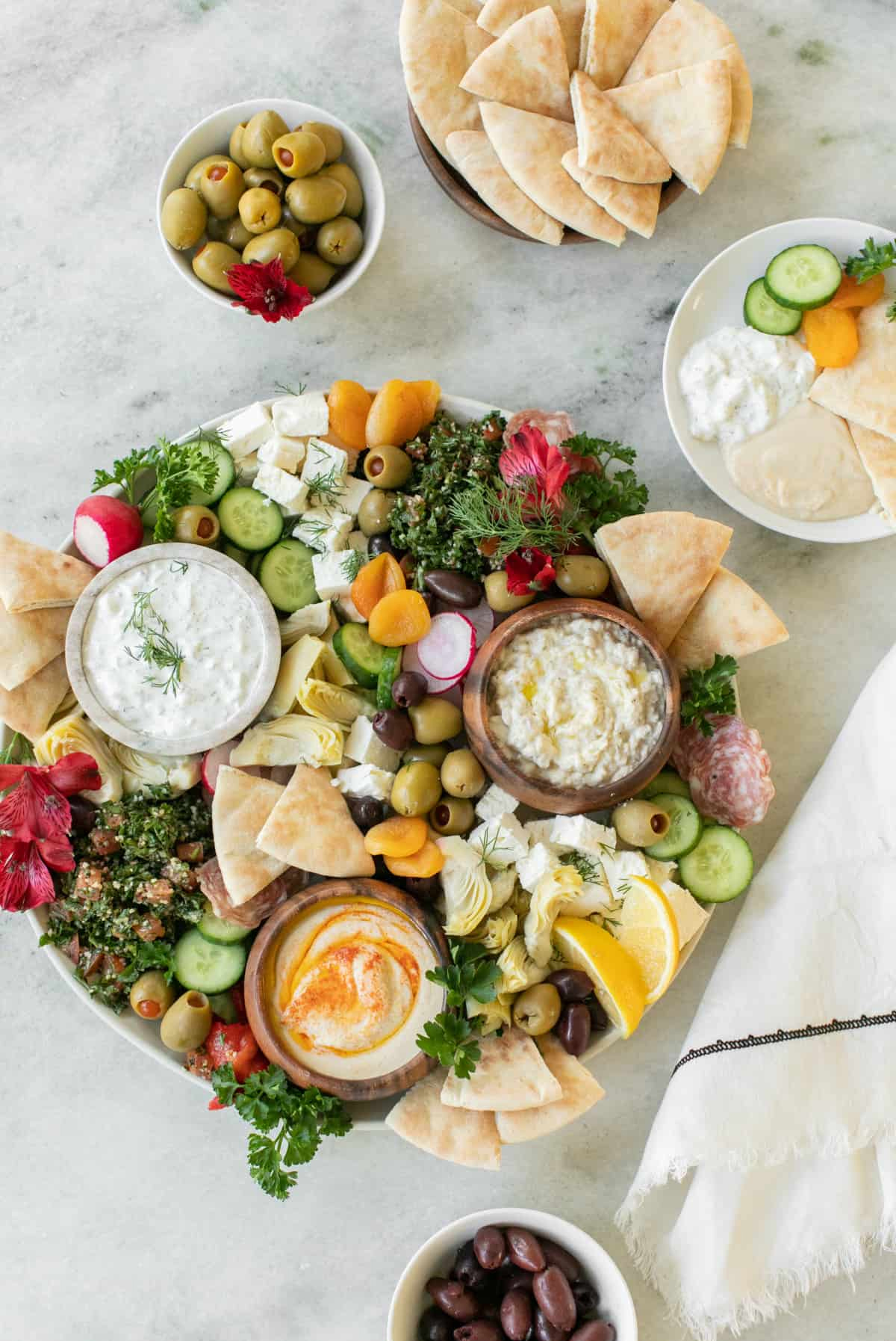 Hummus, pita bread, stuffed olives and cucumber make up a Greek charcuterie board from Sugar and Charm