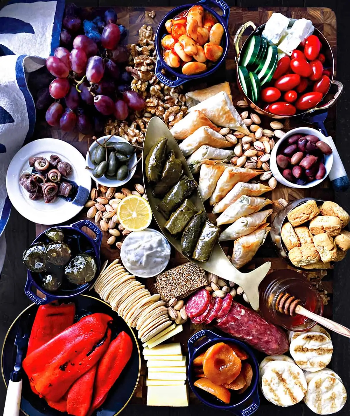 stuffed grape leaves, veggies, and a variety of cracker choices take center stage in this board from the greek foodie.