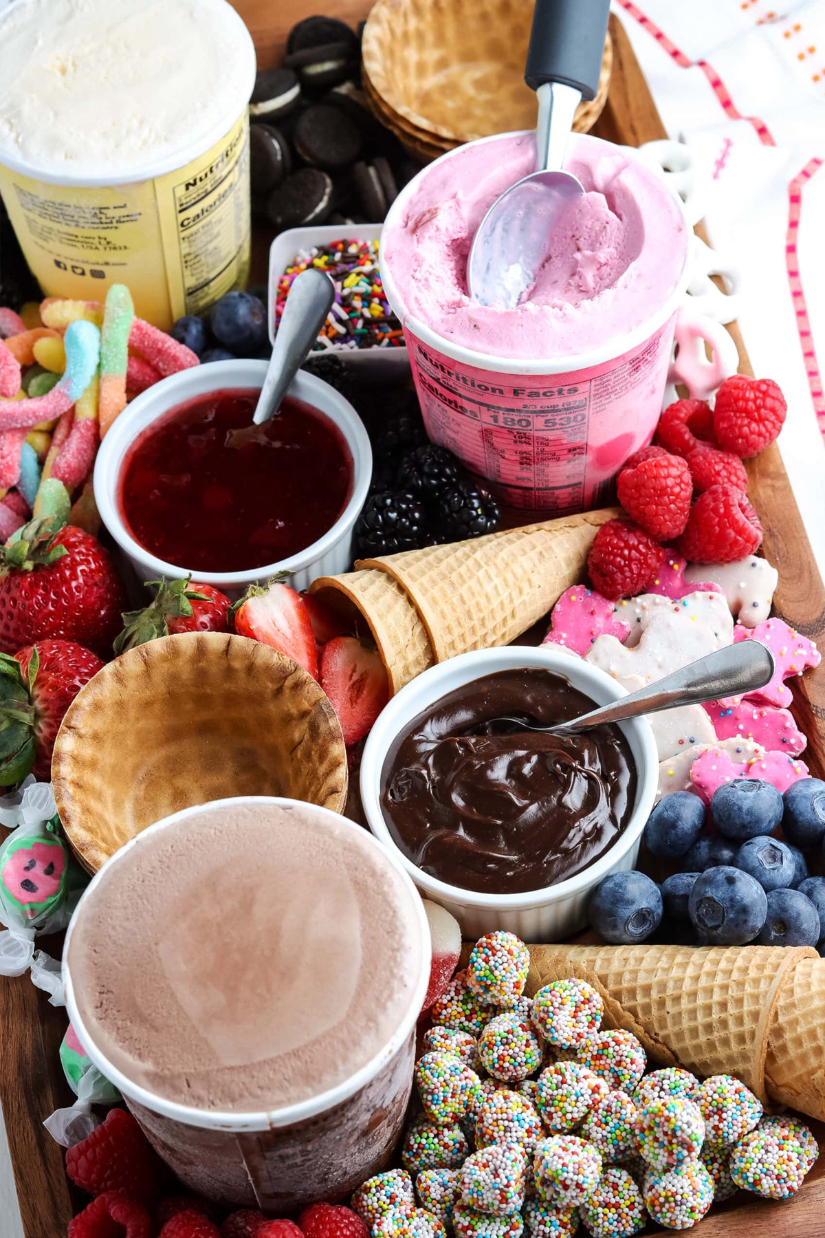 A full ice cream charcuterie board from Mommy Hates Cooking with mini Oreos, gummy worms, fruit, and more! 