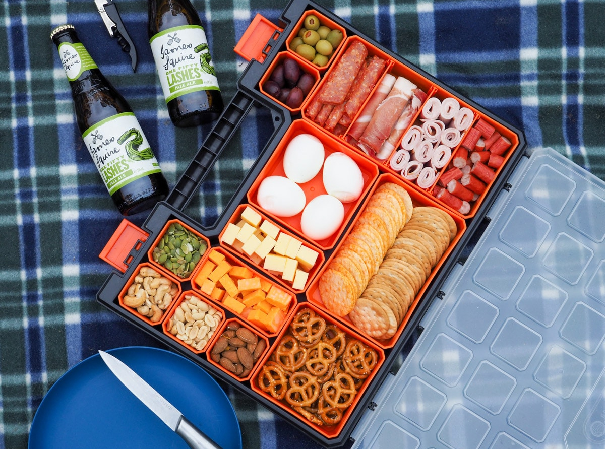 a tackle box filled with foods like turkey, hard-boiled eggs, crackers, cheese, etc from Aussie home cook.