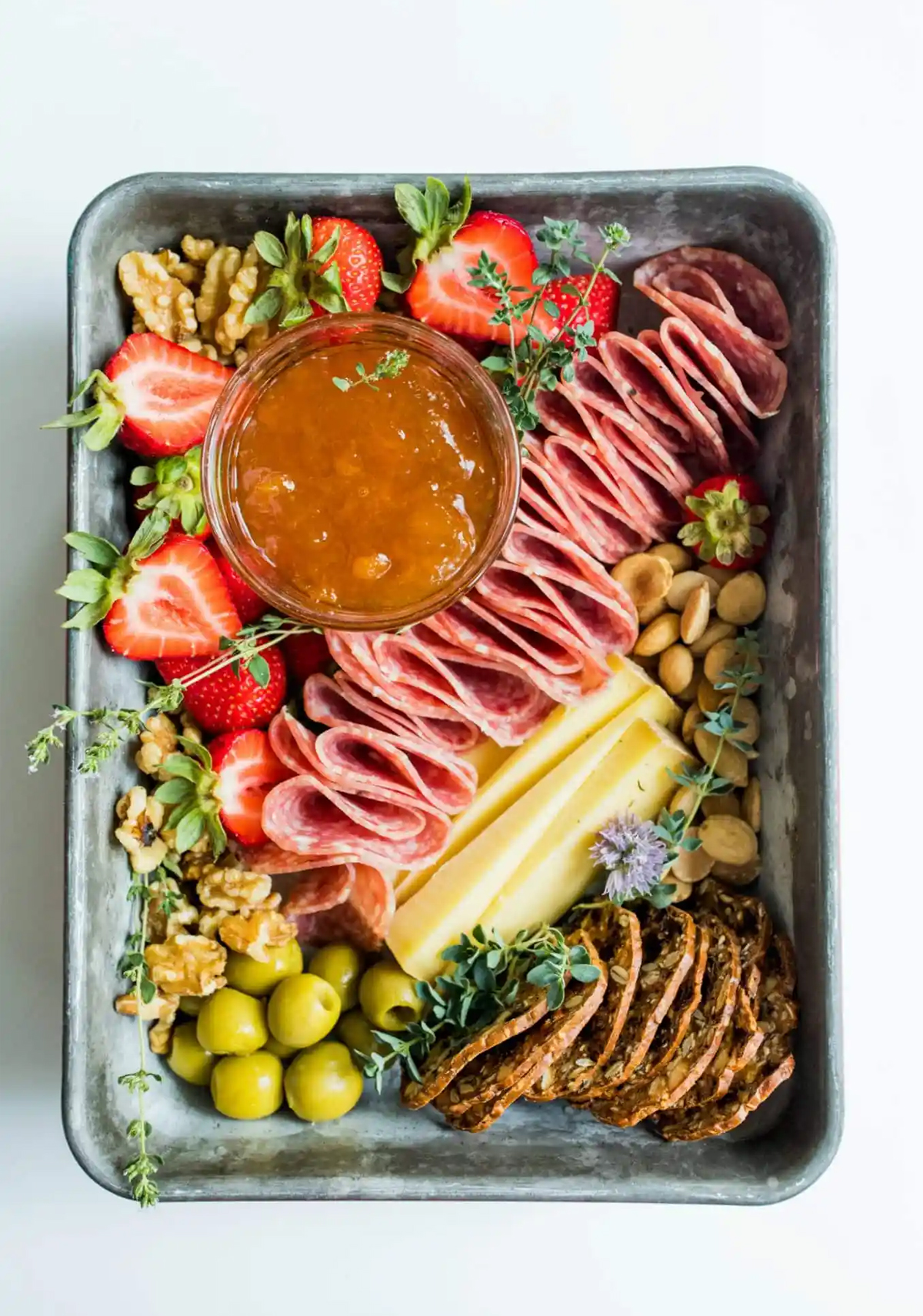 reluctant entertainer created a tray of meat, strawberries, nuts, and jam. The perfect picnic charcuterie board.