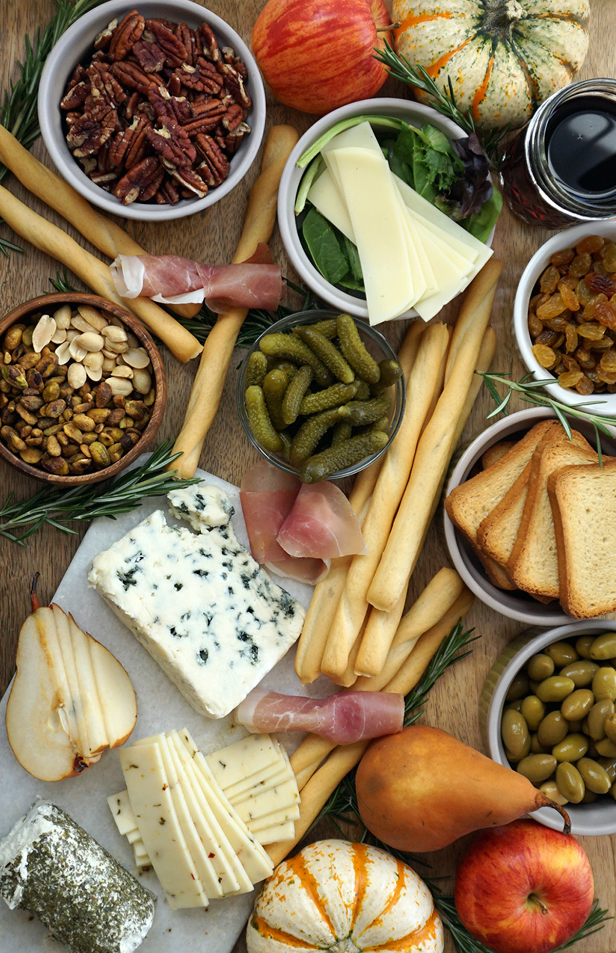 a fall rustic charcuterie board idea with meats, cheese, bread, olives, and more from bijoux & bits.