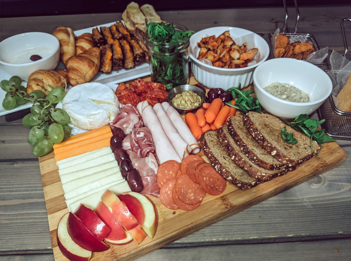 Deli meat, cheese, carrots, and bread is included on Christina Chandra's charcuterie sandwich board.