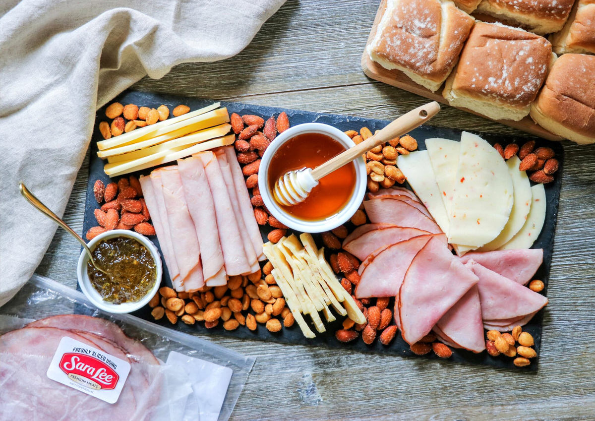 Fab Everyday's sandwich board is full of deli meat, cheese, nuts, bread, and pepper jelly.