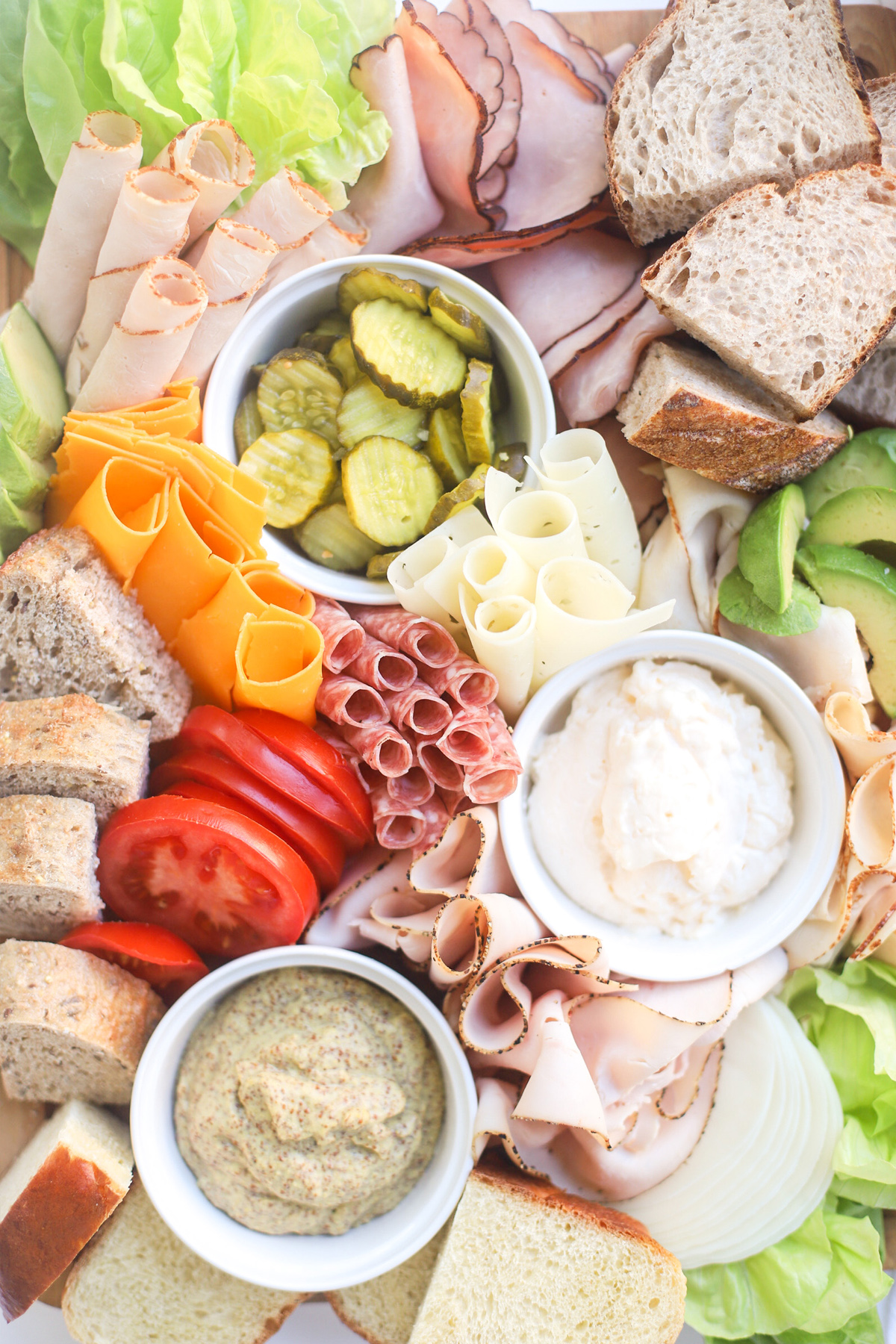 Glitter Inc created a make your own sandwich board full of meat, lettuce, pickles, cheese, and bread.