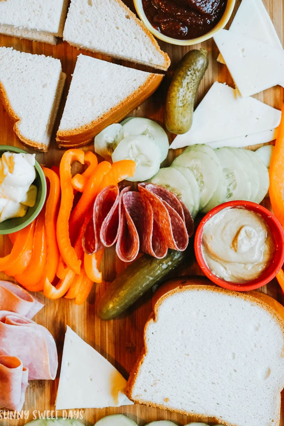 Sunny Sweet Days showcases a completely gluten free sandwich board filled with bread, cheese, pickles, veggies, and meat.