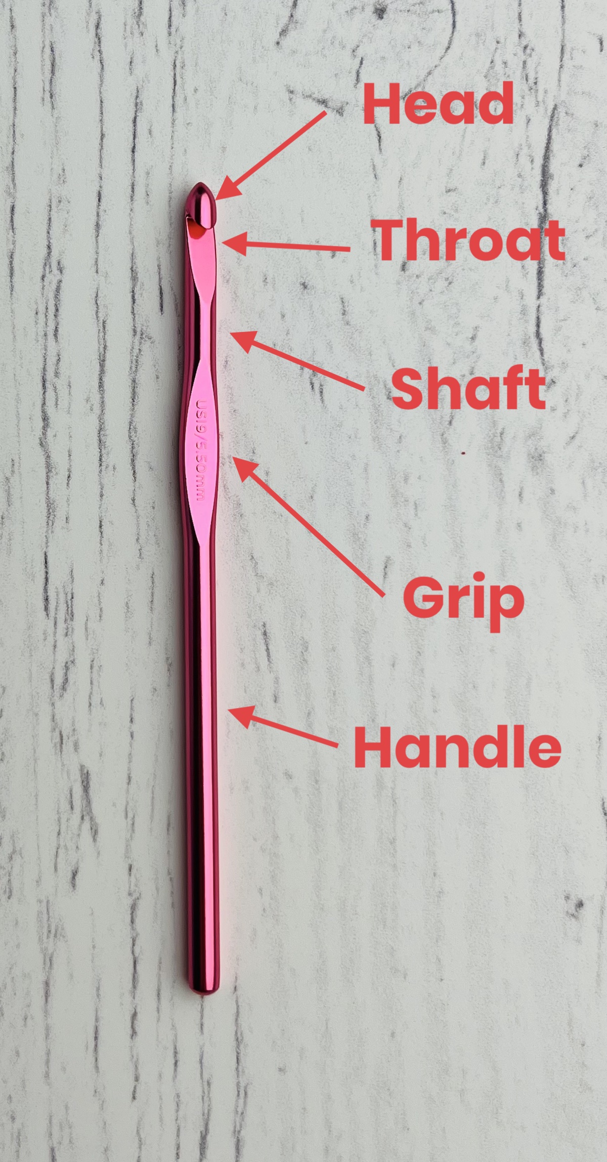 Pink crochet hook with parts labeled