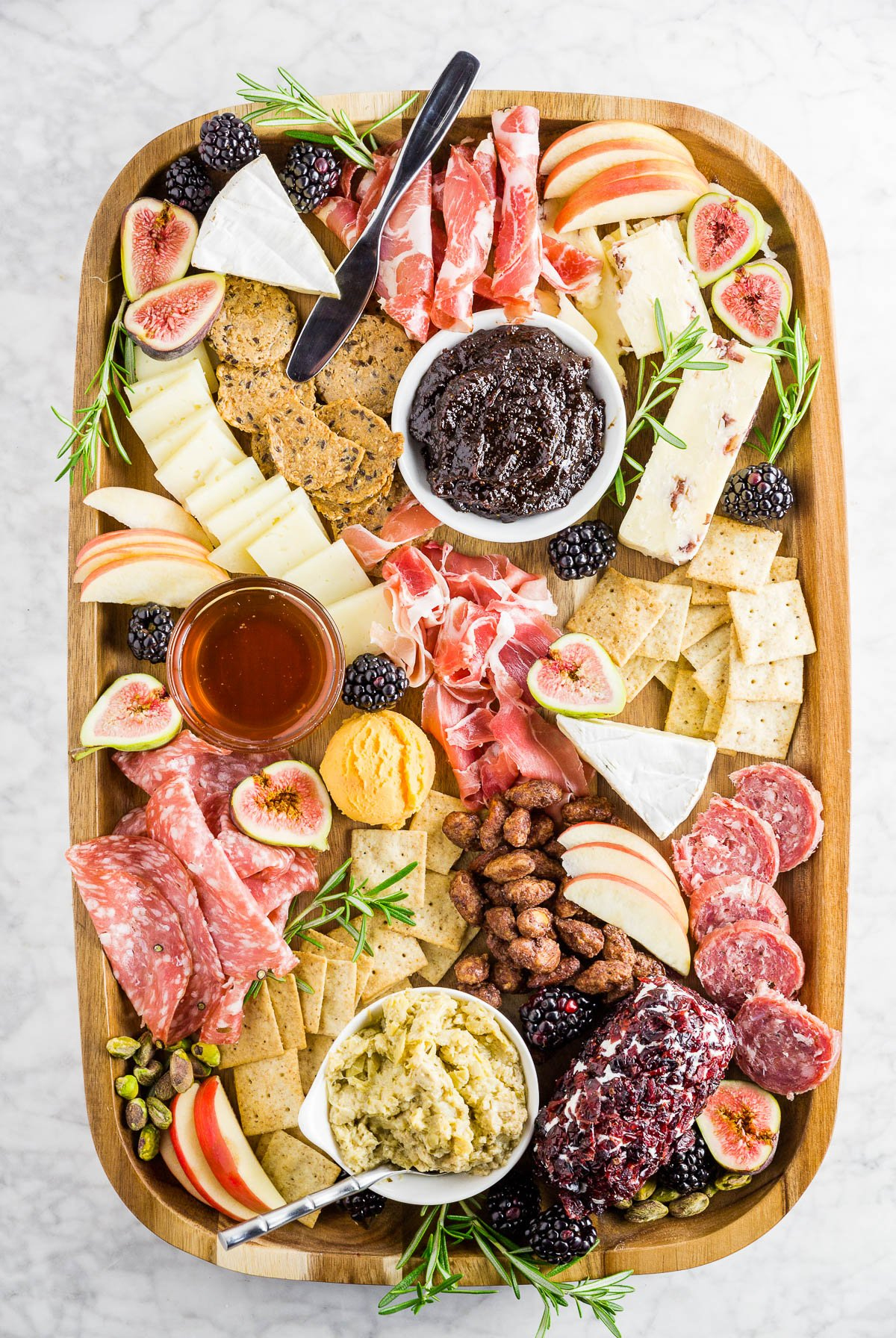 A Dash of Megnut's autumn charcuterie board showcases meats, cheese, berries, and crackers.