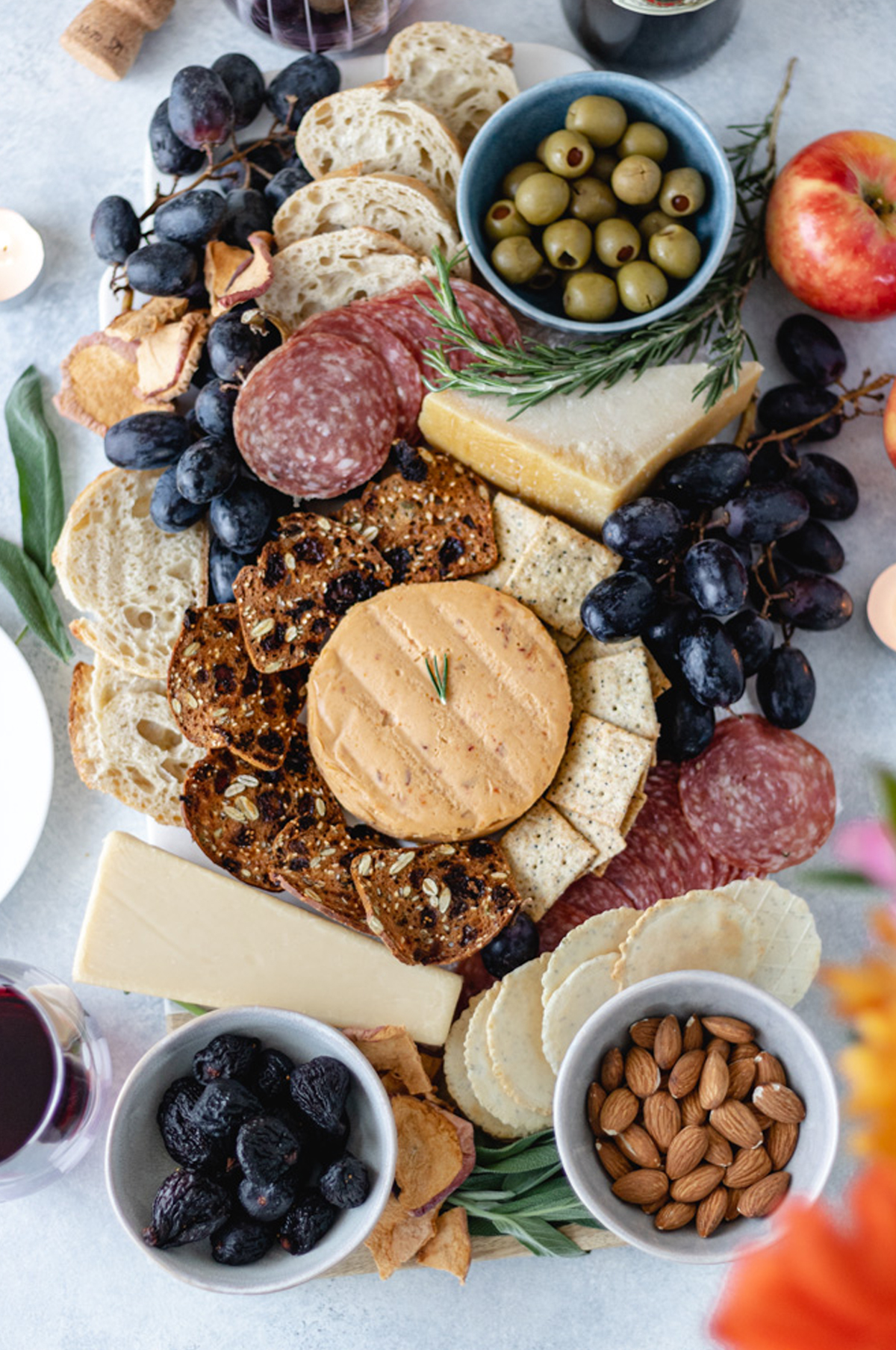 Miyoko’s Garlic Herb Cashew Milk Cheese, Almonds, grapes, olives, meats, and cheese are on A Life Delicious's fall charcuterie board.