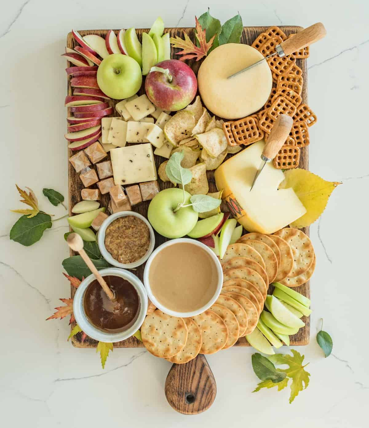 Bless This Mess Please's has created a beautiful board full of different types of cheese and fruit.