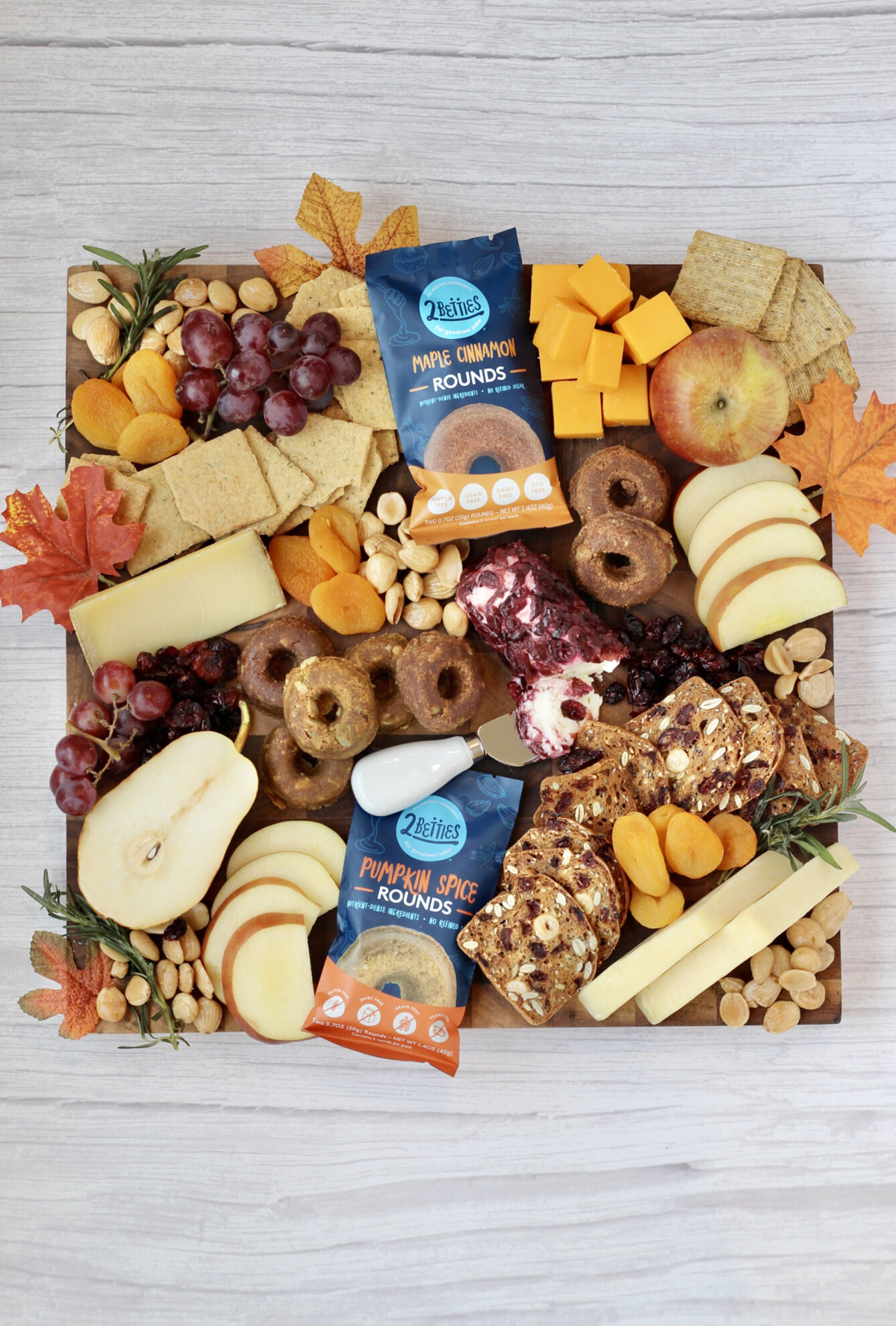 Cheerful Choices' fall board is full of cheese, meats, fruit, donuts, and grapes/
