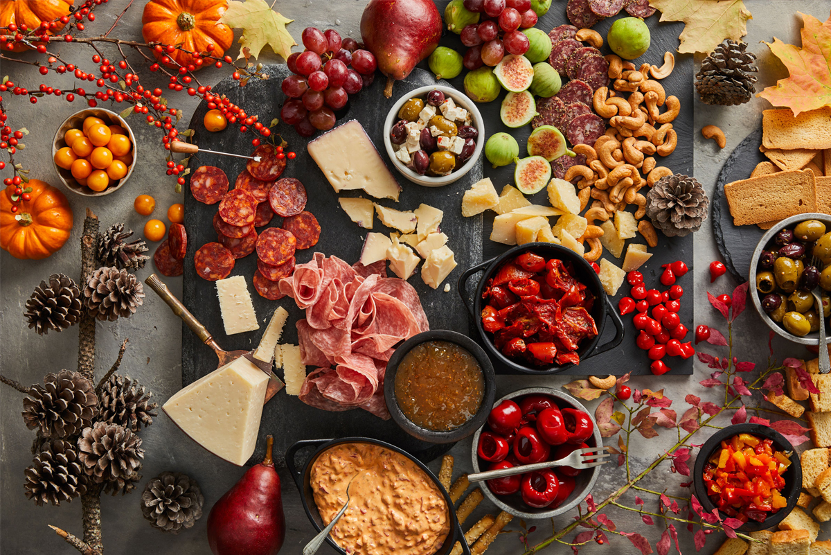 DeLallo showcases cheeses, meats, nuts, and nuts on their fall themed charcuterie board.