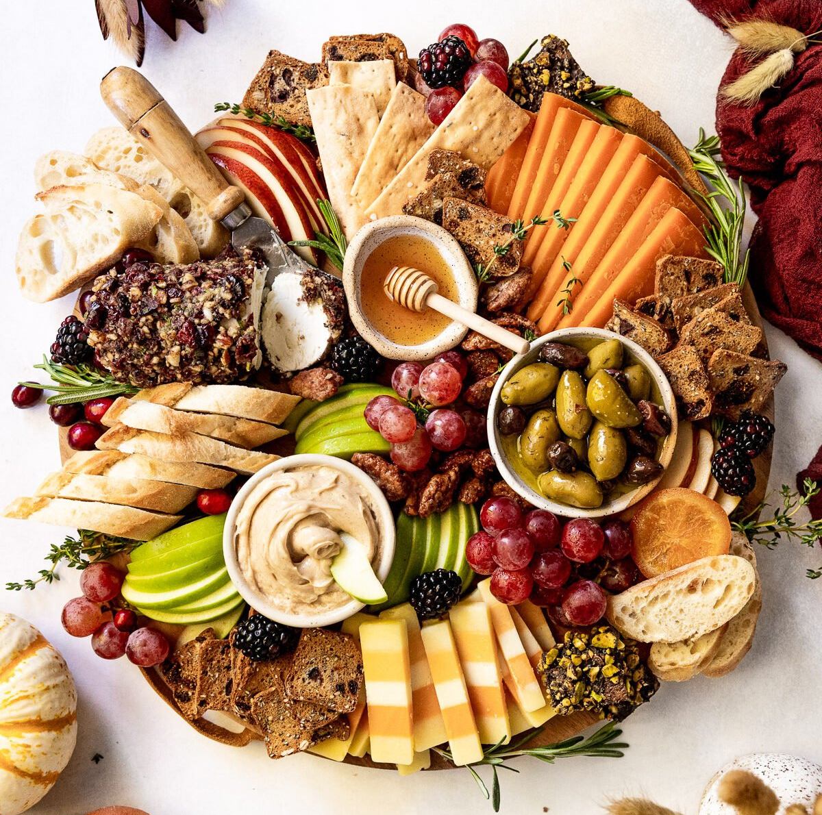 Fork in the Kitchen's fall charcuterie board is full of cheese, grapes, olives, breads, and meat.
