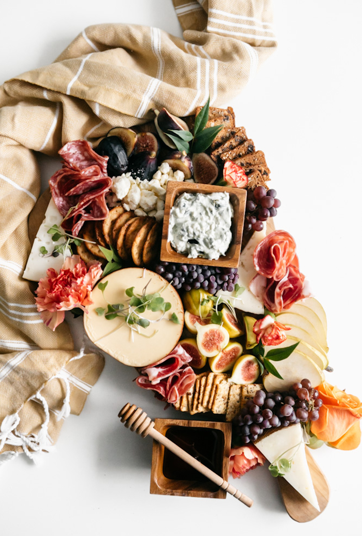 Heather's Home Bakery's fall board includes crackers, honey, figs, meat, and cheese.