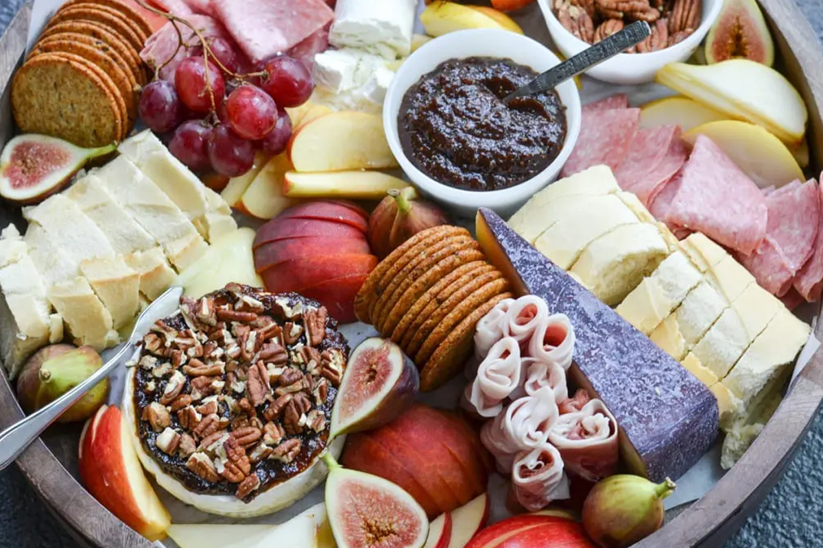 Home Sweet Table's fall board has pecan-topped brie, goat cheese, salami, and crackers.