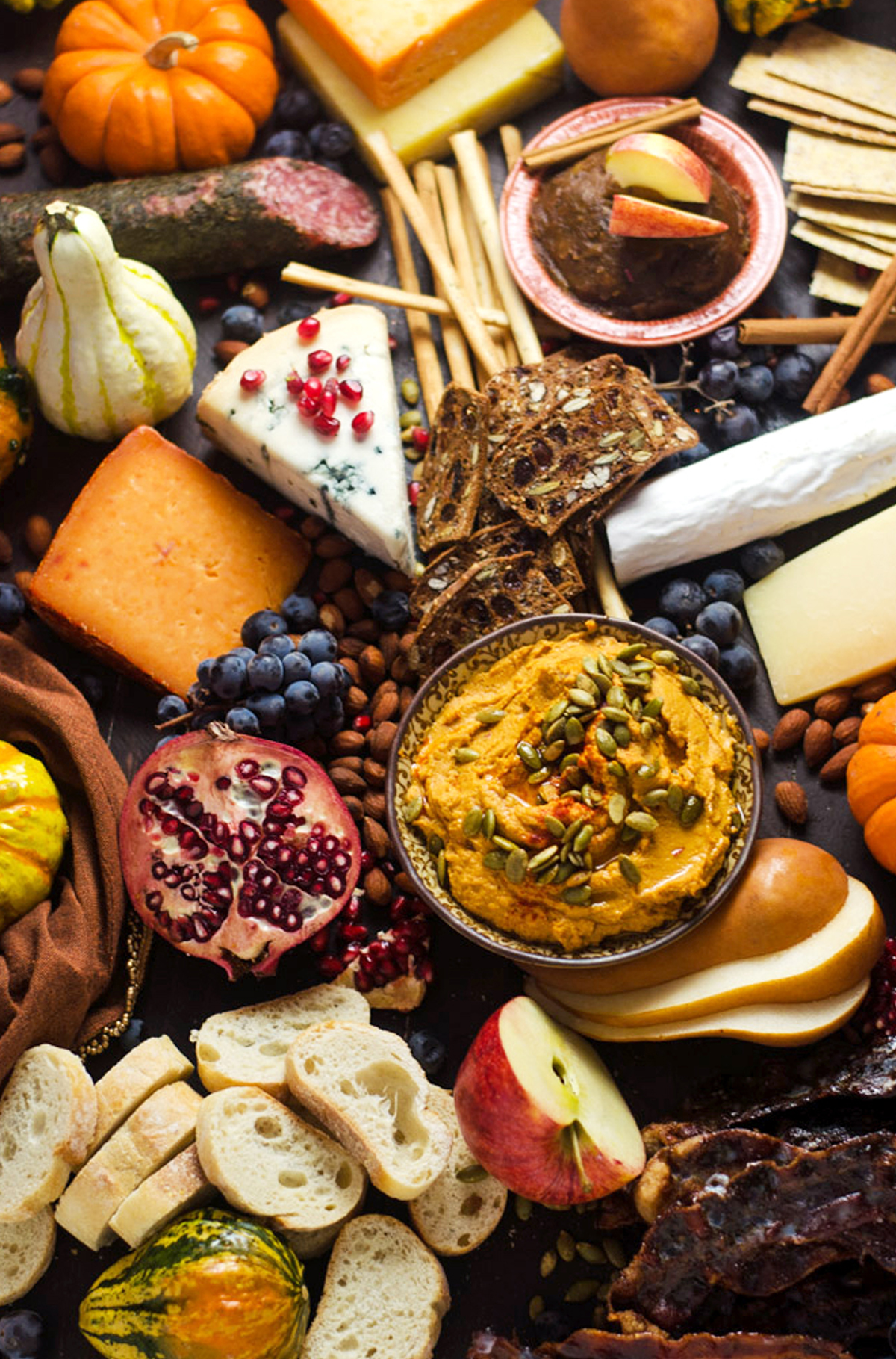 Host the Toast's autumn charcuterie board is filled with candied bacon, cheese, crackers, meats, and fruit.