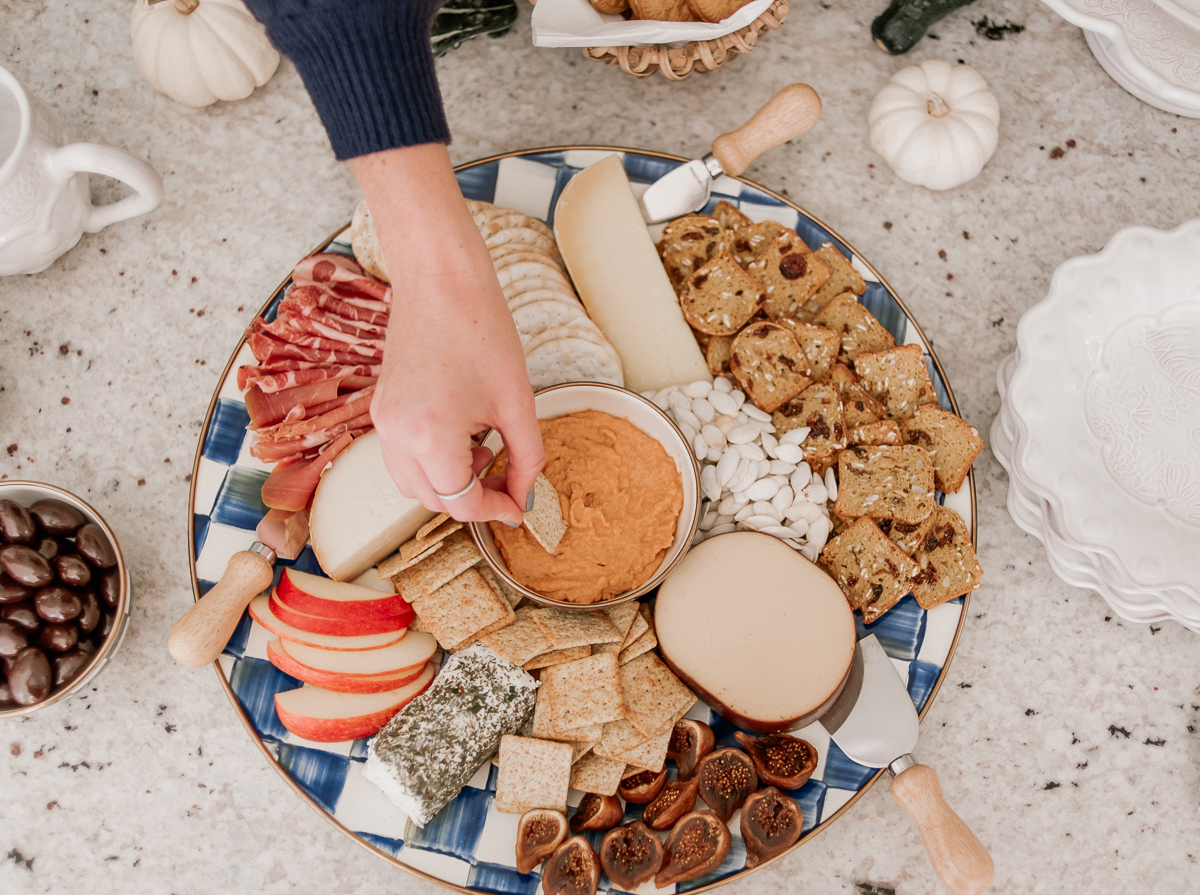 Louella Reese's plate is full of cheeses, meat, dip, crackers, and fruit.