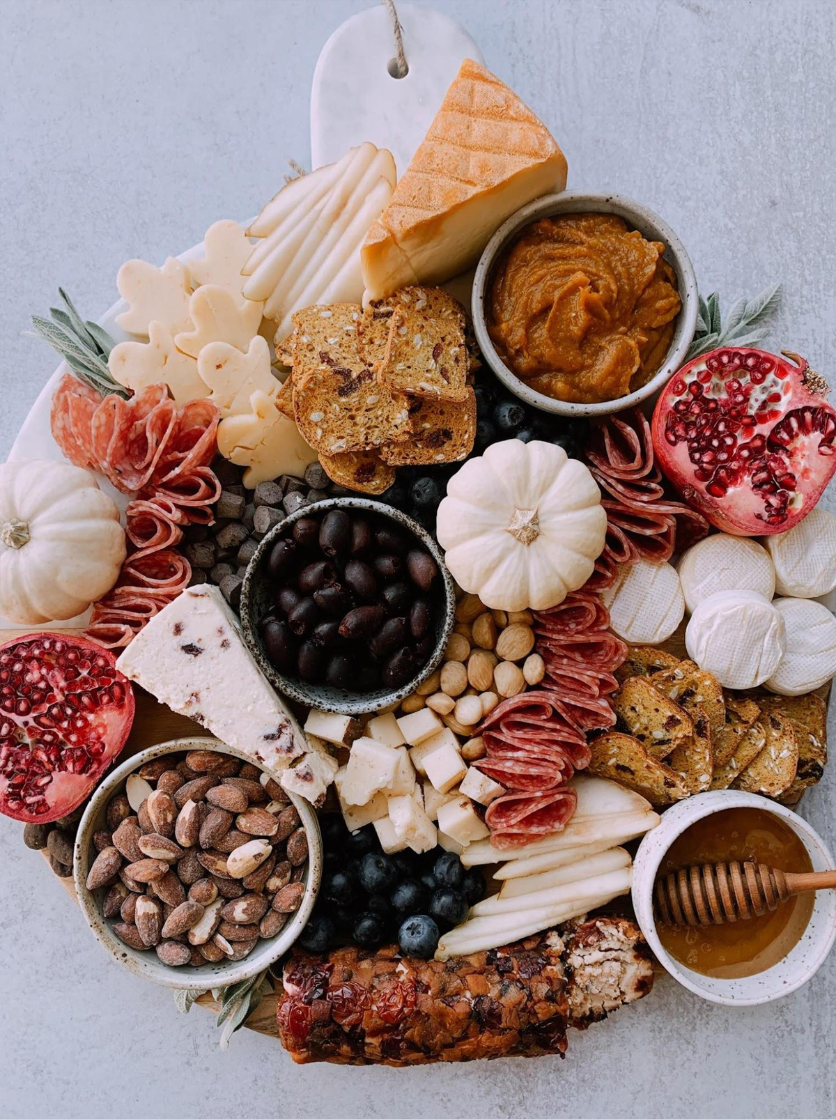 Melissa's Healthy Kitchen's autumn board is filled with nuts, cheese, honey, meats, olives, and crackers.