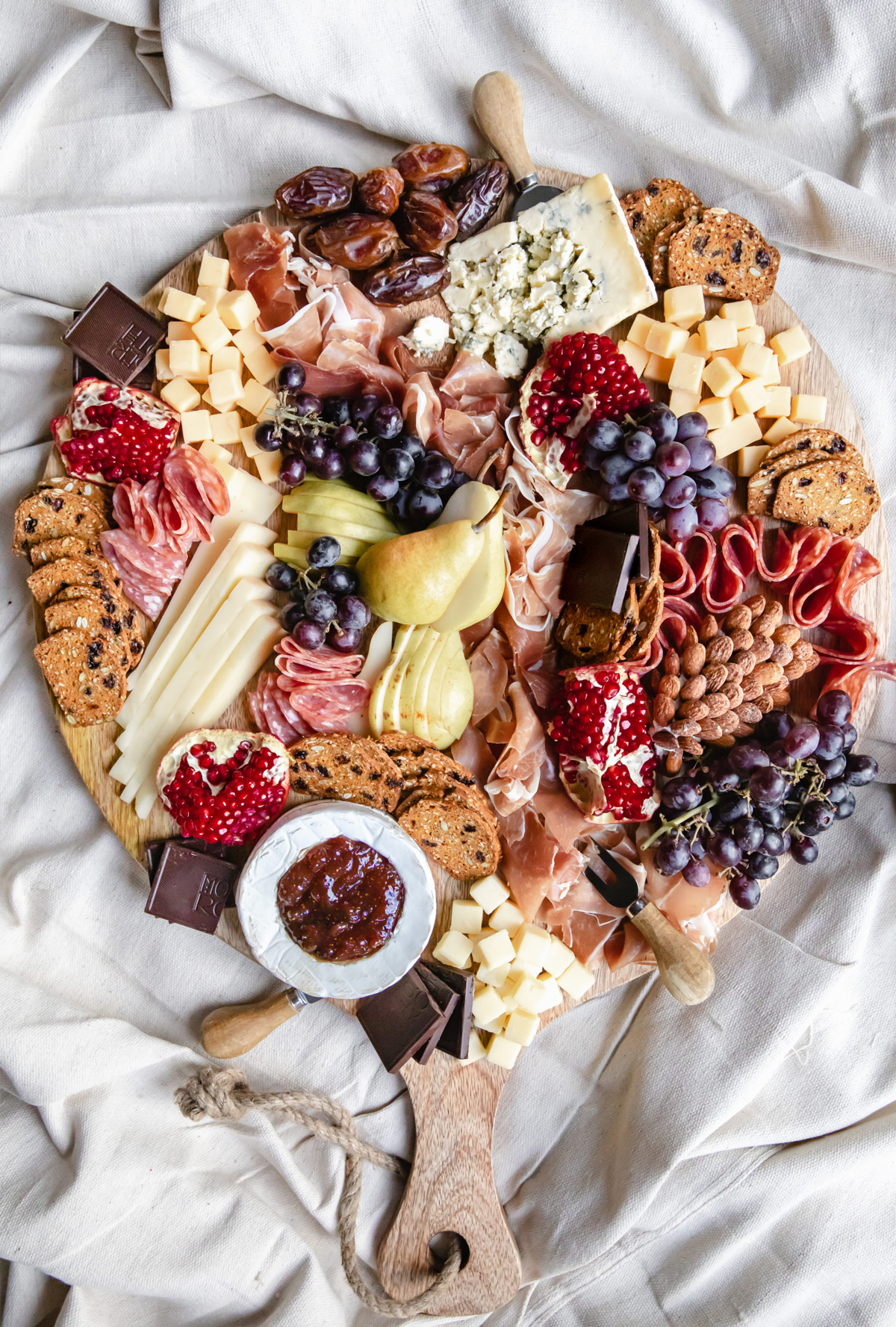 Prunes, grapes, pomegranates are cheeses, meats,  and chocolate are on Rosalynn Daniels' autumn charcuterie board.
