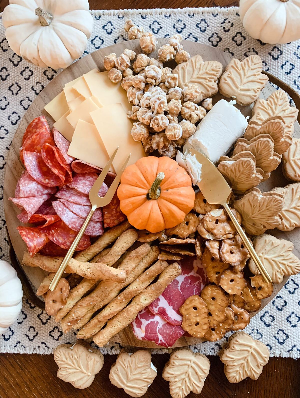 Stickers and Stilettos shows a beautiful fall board full of goat cheese, maple leaf cookies, pretzels, and popcorn.