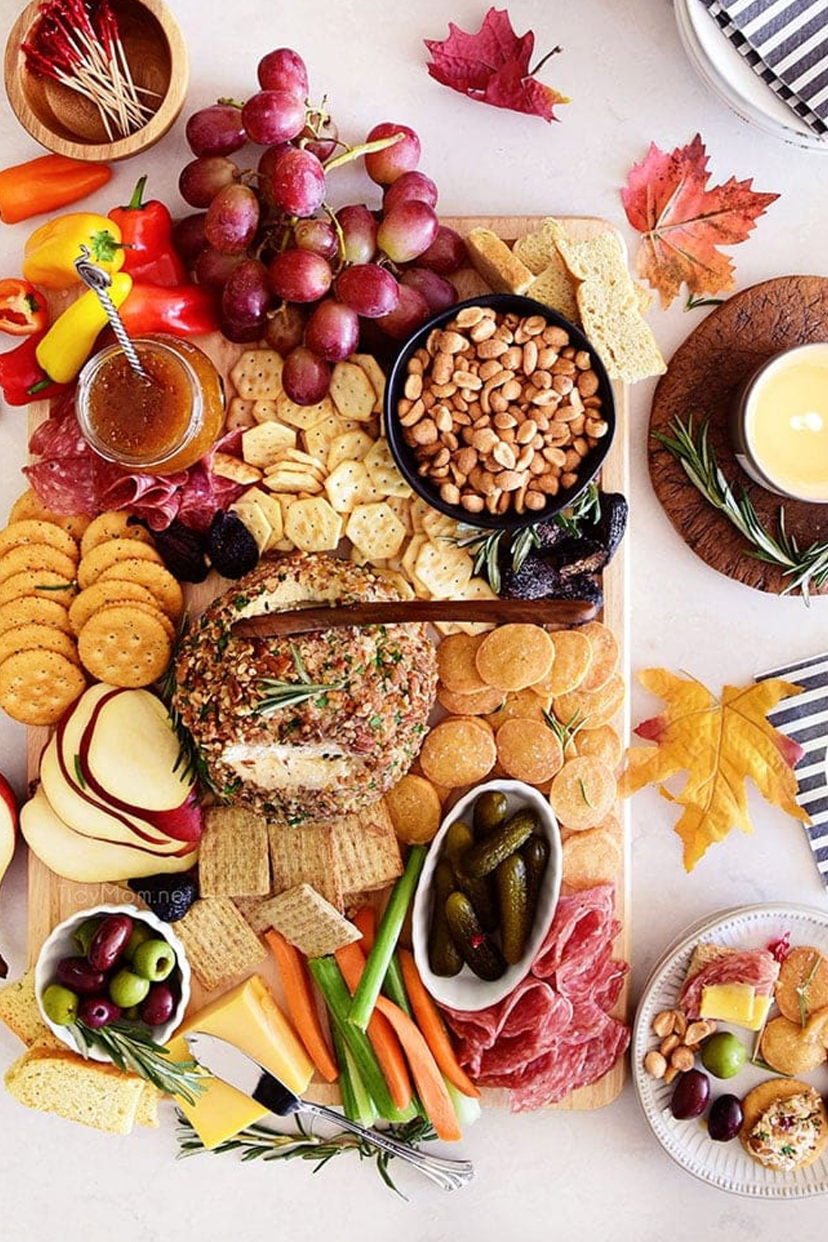 Tidy mom's charcuterieboard with crackers, cheese, nuts, and more. 