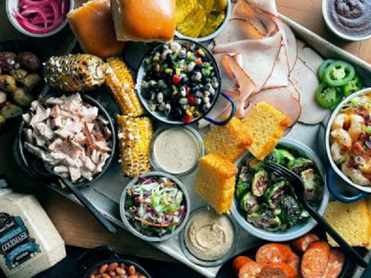 boar's head used their deli meat to create a bbq charcuterie board and also included different sides like pasta salad, corn, and more.