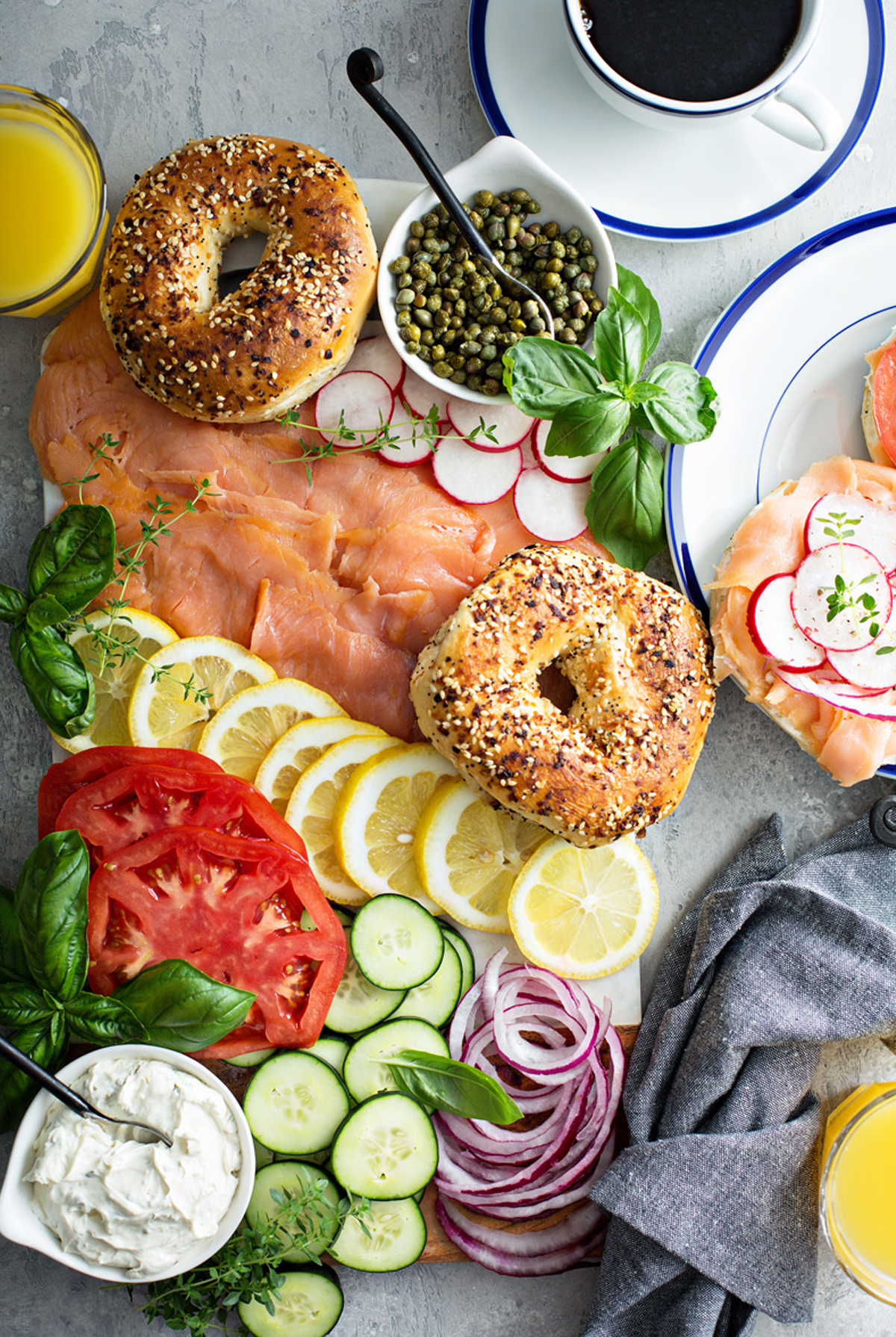 a food lover's kitchen charcuterie board with capers, bagels, lox, and more.