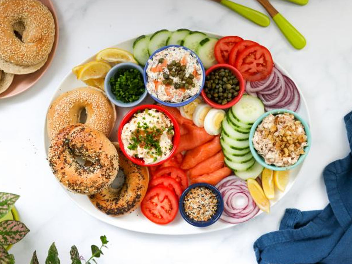 make a bagel choices and top it with cream cheese, cucumbers, tomatoes, and more from the food network.